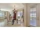 Bright dining area with glass table, chandelier, and access to kitchen at 1908 Scarlett Ave, North Port, FL 34289