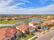 Aerial view of upscale community with lake and numerous homes at 20717 Benissimo Dr, Venice, FL 34293