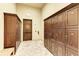 Locker room with wooden lockers, tile floors and bench at 20717 Benissimo Dr, Venice, FL 34293