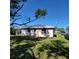 Rear view of the house showcasing a metal roof and a large backyard at 2306 6Th Avenue E Dr, Bradenton, FL 34208