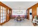 Dining room featuring wood paneling, tile flooring, and a dining table at 2669 Prospect St, Sarasota, FL 34239