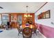 Dining area with tile floors, charming light fixture, and door to the sunroom at 2669 Prospect St, Sarasota, FL 34239