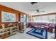 Cozy living room with wood paneling, ceiling fan, and plush seating at 2669 Prospect St, Sarasota, FL 34239