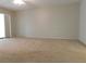 Spacious bedroom with neutral-colored carpet and sliding glass doors at 302 Spring Lakes Blvd # 302, Bradenton, FL 34210