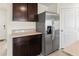 Kitchen features stainless steel refrigerator and ample cabinet space at 3284 Silver Date Dr, Wimauma, FL 33598