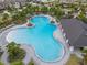 Aerial view of a community pool with a large seating area at 3284 Silver Date Dr, Wimauma, FL 33598