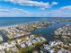 Expansive aerial view of a coastal home on a canal with easy access to the bay and a nearby sandy beach at 329 Tarpon St, Anna Maria, FL 34216