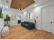 Bright bonus room with hardwood floors, sofa, and laundry access at 329 Tarpon St, Anna Maria, FL 34216
