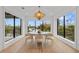 Elegant dining room with a round table, light beige chairs and water views at 329 Tarpon St, Anna Maria, FL 34216