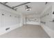 Clean and organized garage featuring slatwall storage and epoxy flooring at 329 Tarpon St, Anna Maria, FL 34216