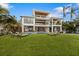 Modern two-story home with artificial turf, pool, and canal views at 329 Tarpon St, Anna Maria, FL 34216