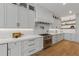 Modern kitchen with white cabinets, quartz countertops, and stainless steel appliances at 329 Tarpon St, Anna Maria, FL 34216