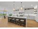 Modern kitchen with white cabinets, large island, and quartz countertops at 329 Tarpon St, Anna Maria, FL 34216