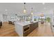 Open concept kitchen with island, stainless steel appliances, and marble countertops at 329 Tarpon St, Anna Maria, FL 34216