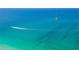 Stunning aerial view of a parasailor and boat in the ocean at 329 Tarpon St, Anna Maria, FL 34216