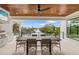 Covered outdoor kitchen and dining area with water views at 329 Tarpon St, Anna Maria, FL 34216
