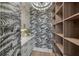 Elegant pantry with wood shelving and tropical-themed wallpaper at 329 Tarpon St, Anna Maria, FL 34216