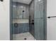 Spa-like shower with blue tile, built-in niche, and glass enclosure at 329 Tarpon St, Anna Maria, FL 34216