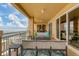 Large balcony with outdoor seating, water views, and a stylish rug at 35 Watergate Dr # 1203, Sarasota, FL 34236