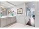 Spa-like bathroom with double vanity and ocean-themed art at 35 Watergate Dr # 1203, Sarasota, FL 34236