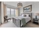 Guest bedroom with water views and comfortable sitting area at 35 Watergate Dr # 1203, Sarasota, FL 34236