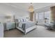 Main bedroom with water views and a comfortable sitting area at 35 Watergate Dr # 1203, Sarasota, FL 34236