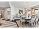 Elegant dining room with a large table, chandelier, and modern art at 35 Watergate Dr # 1203, Sarasota, FL 34236