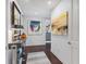 Bright hallway with hardwood floors and artwork at 35 Watergate Dr # 1203, Sarasota, FL 34236