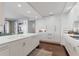 Modern kitchen with white cabinets, quartz countertops and island at 35 Watergate Dr # 1203, Sarasota, FL 34236