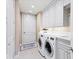Laundry room with side-by-side washer and dryer, white cabinets, and built-in countertop at 35 Watergate Dr # 1203, Sarasota, FL 34236