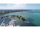 Aerial view of a marina and surrounding park, showing boats and calm waters at 35 Watergate Dr # 1203, Sarasota, FL 34236