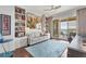 Bright office with water views, built-in shelves, and a comfortable couch at 35 Watergate Dr # 1203, Sarasota, FL 34236