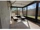 Relaxing screened porch with lounge chairs and tiled flooring at 3629 Taro Pl, Sarasota, FL 34232