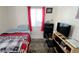 Small bedroom with a twin bed and a TV at 3826 Rilma Ave, Sarasota, FL 34234