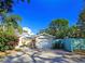 Bright front yard with palm trees and well-maintained landscaping at 3826 Rilma Ave, Sarasota, FL 34234