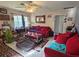 Living room with red couches and a coffee table at 3826 Rilma Ave, Sarasota, FL 34234