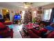 Living room with red couches, TV, and Christmas decorations at 3826 Rilma Ave, Sarasota, FL 34234