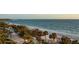 Stunning beachfront view with palm trees and white sand beach at 435 L Ambiance Dr # M408, Longboat Key, FL 34228