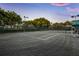 Well-maintained tennis court with surrounding greenery at 435 L Ambiance Dr # M408, Longboat Key, FL 34228