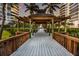 Scenic walkway to the pool area with a wooden gazebo at 435 L Ambiance Dr # M408, Longboat Key, FL 34228