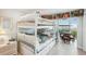 Bedroom with white bunk bed and access to balcony at 4430 Exeter Dr # M108, Longboat Key, FL 34228
