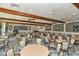 Community dining room with multiple tables and chairs at 4430 Exeter Dr # M108, Longboat Key, FL 34228
