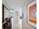 Bright hallway with tiled floor and elegant wood accent table and mirror at 4430 Exeter Dr # M108, Longboat Key, FL 34228