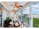 Sunroom with water views and dining table at 4430 Exeter Dr # M108, Longboat Key, FL 34228