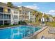 Community pool with lounge chairs and umbrellas at 4430 Exeter Dr # M108, Longboat Key, FL 34228