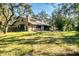 Spacious backyard with grassy area and mature trees at 4938 Hubner Cir, Sarasota, FL 34241