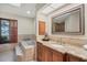 Primary bathroom with a large soaking tub and granite vanity at 4938 Hubner Cir, Sarasota, FL 34241