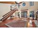 Living room with hardwood floors, high ceilings, and a wooden staircase at 4938 Hubner Cir, Sarasota, FL 34241