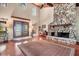 Living room with stone fireplace and hardwood floors at 4938 Hubner Cir, Sarasota, FL 34241