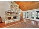Living room with stone fireplace and access to backyard at 4938 Hubner Cir, Sarasota, FL 34241